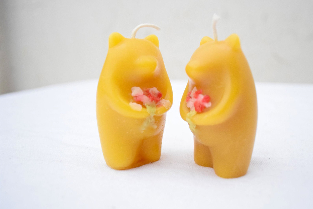 two beeswax candles shaped into bears