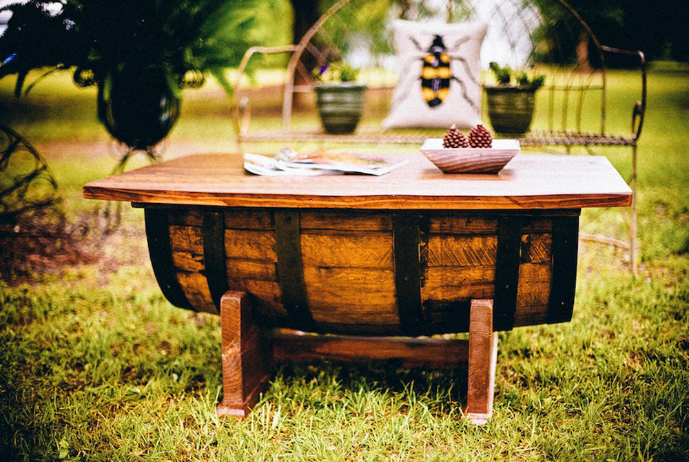 Half a repurposed barrel reconstructed to be used as an outdoor coffee table