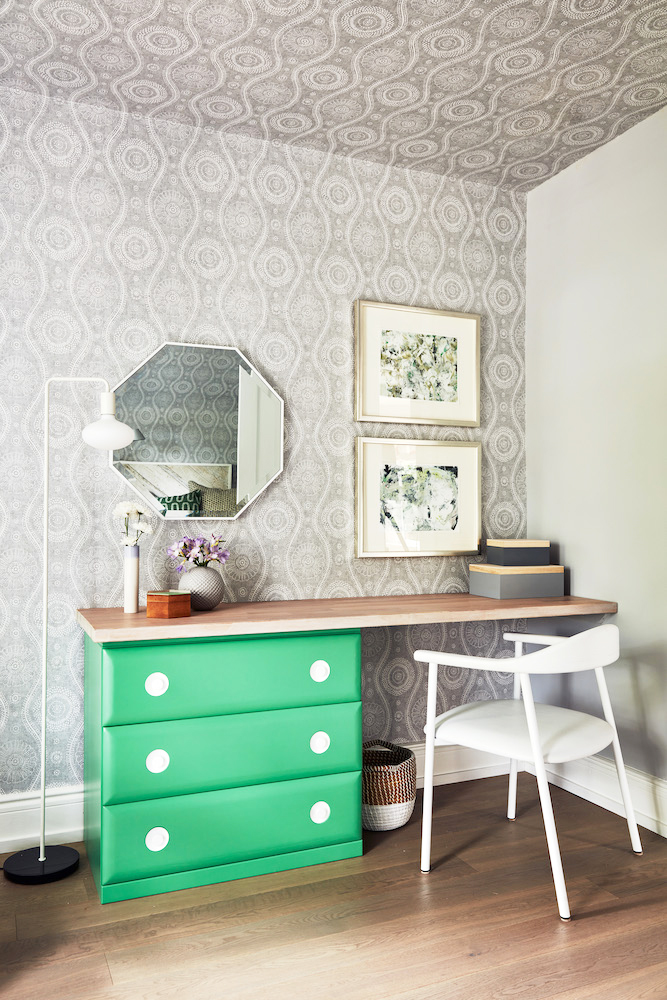 A mint green vanity/desk constructed out of thrifted materials