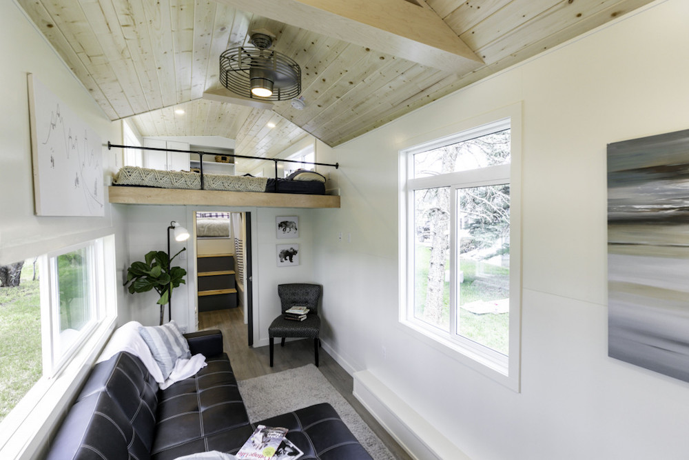 interior of white tiny home living space with side windows