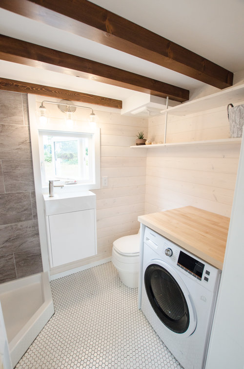 bright white bathroom with laundry machine in tiny home