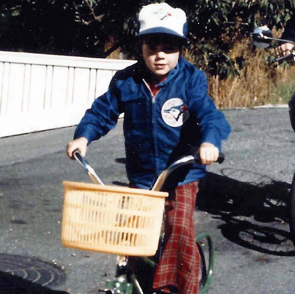 Todd Talbot as a young kid riding a bicycle