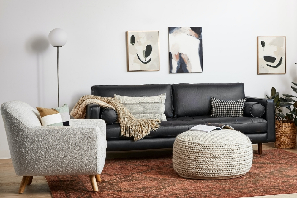 White boucle chair in a modern living room with a burnt orange area rug