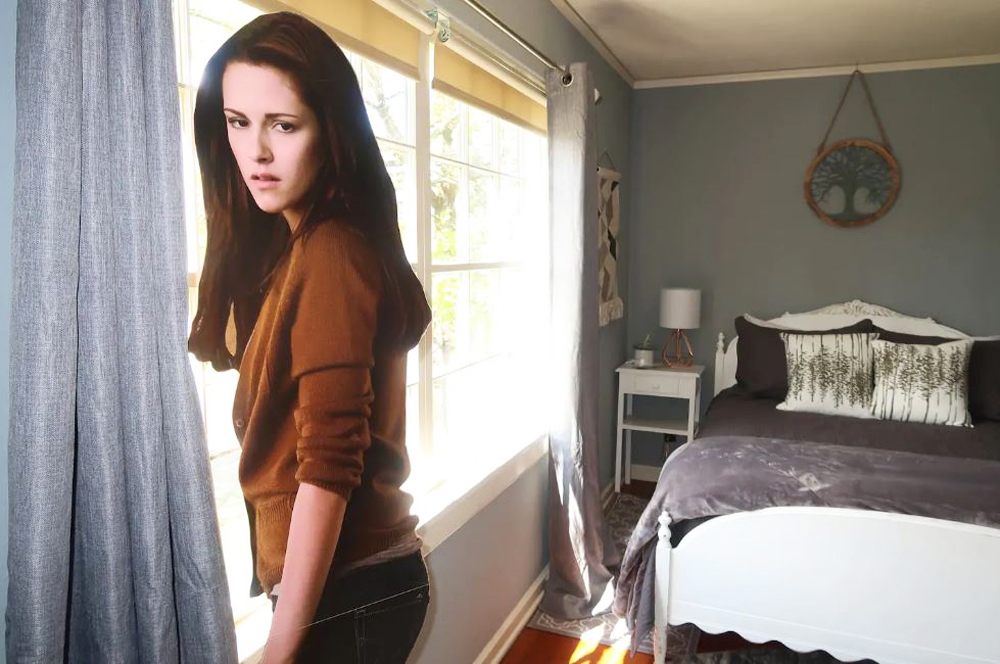 A cardboard cutout of Kristen Stewart from Twilight in a tiny guest bedroom