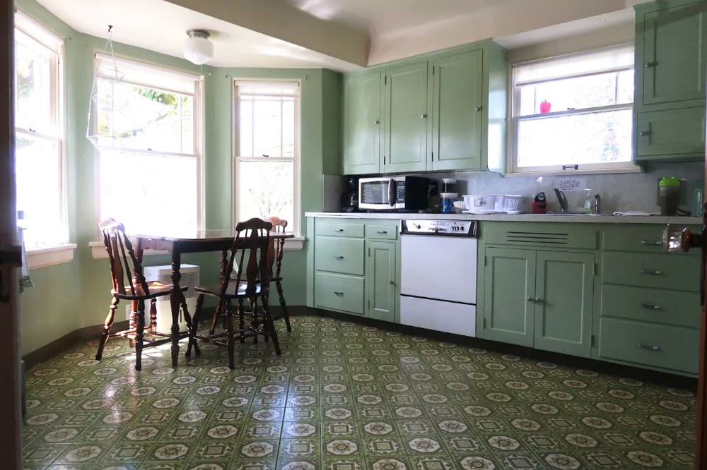 Vintage kitchen with green cabinets and floor tiles