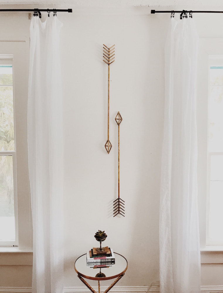 white wall with sculptural arrows