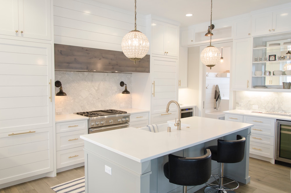 spacious modern white kitchen with hidden hood range and white island