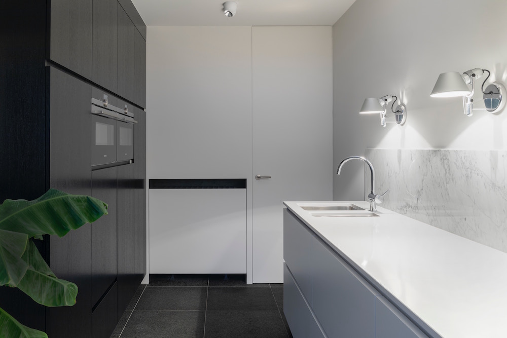 modern kitchen with dark floor-to-ceiling cabinets