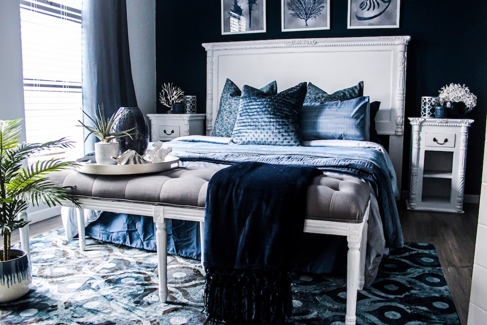blue bedroom with white-and-blue bed and rug