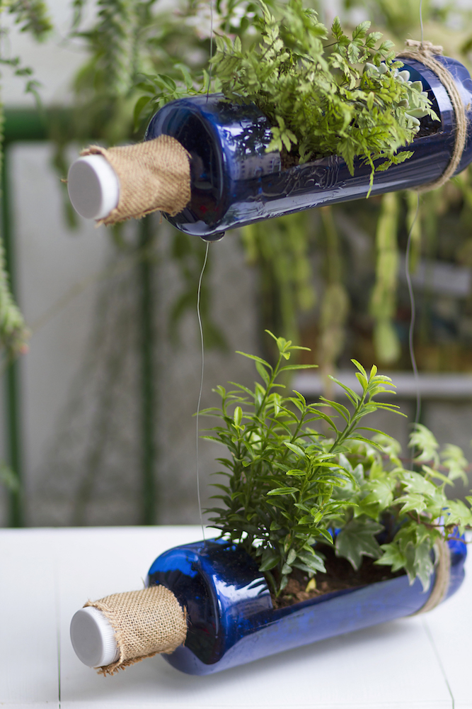blue bottles upcycled into vertical garden