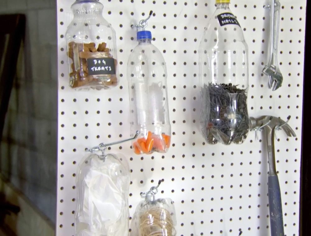 white pegboard DIY with hanging plastic bottles
