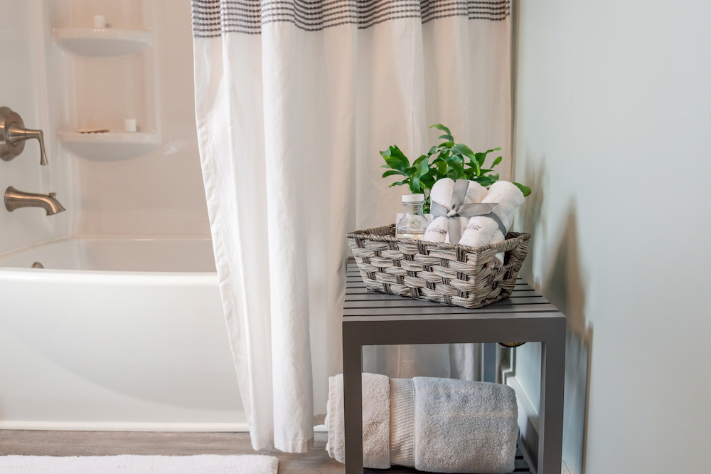 clean modern bathroom decorated in gray and white with shower curtain