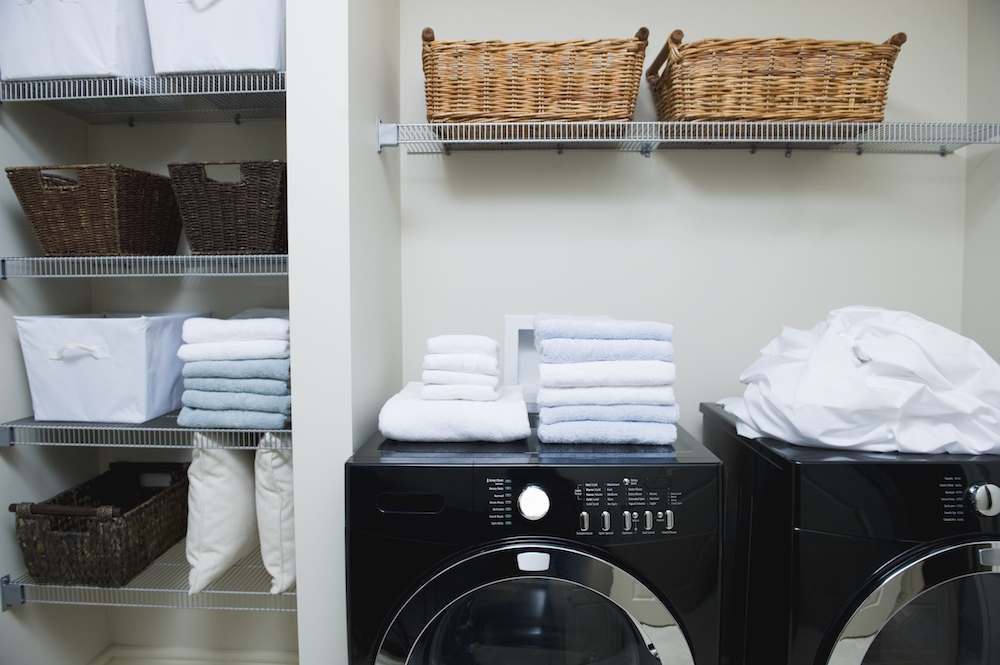 white laundry room with shelves and baskets