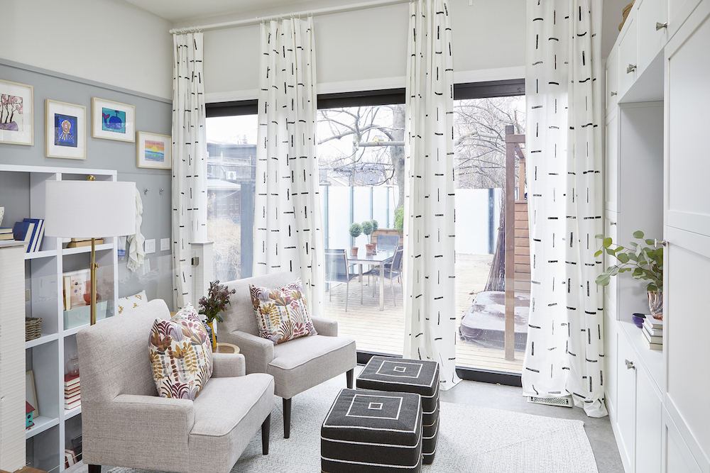 grey family living room with black-and-white paneled curtains