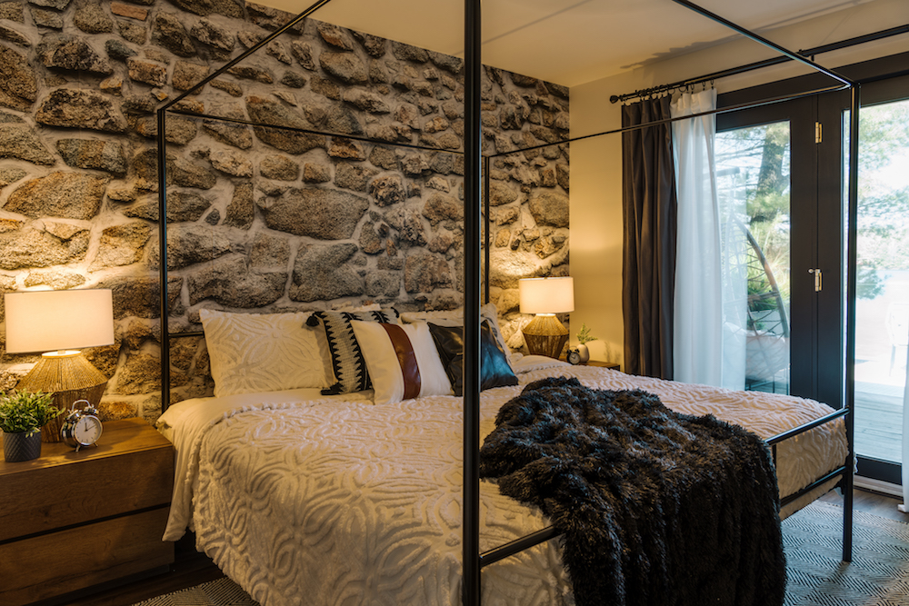 Bedroom with stone wallpaper and walkout deck