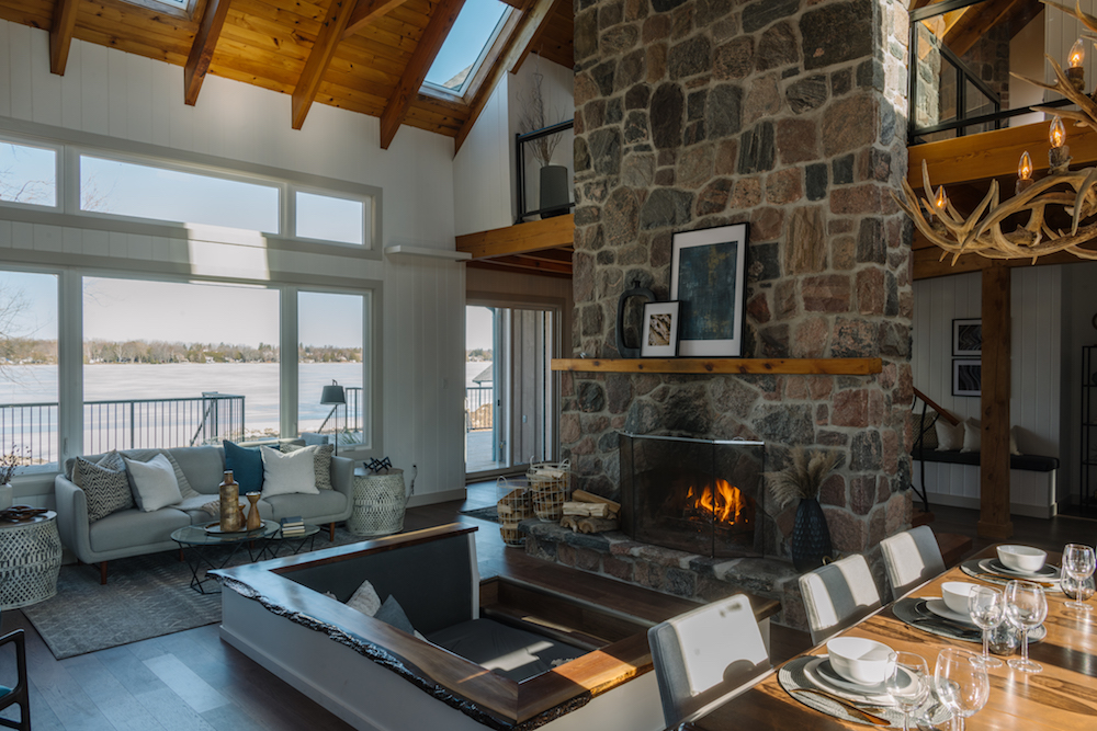 Vacation home interior with stone fireplace and lake view