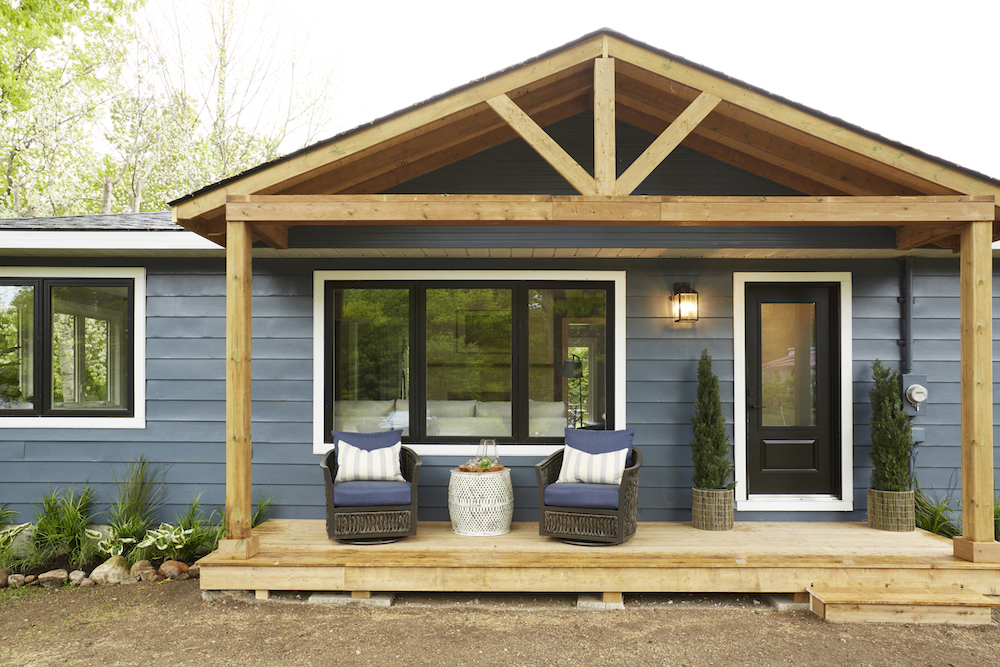 Blue vacation home with wood portico and seating area