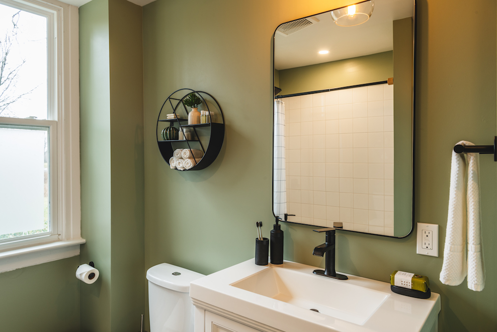 Green bathroom with black finishes