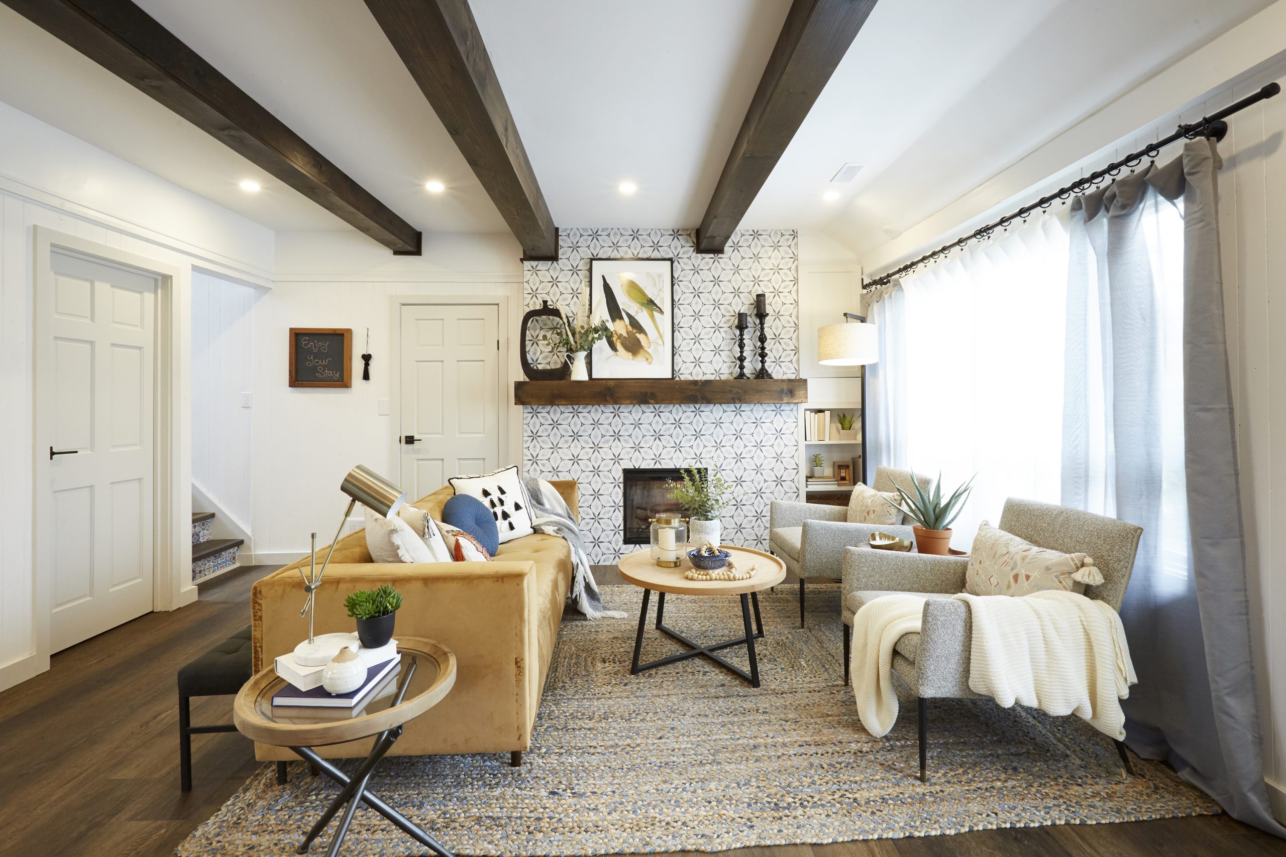 Cozy living room with tiled fireplace and exposed beams