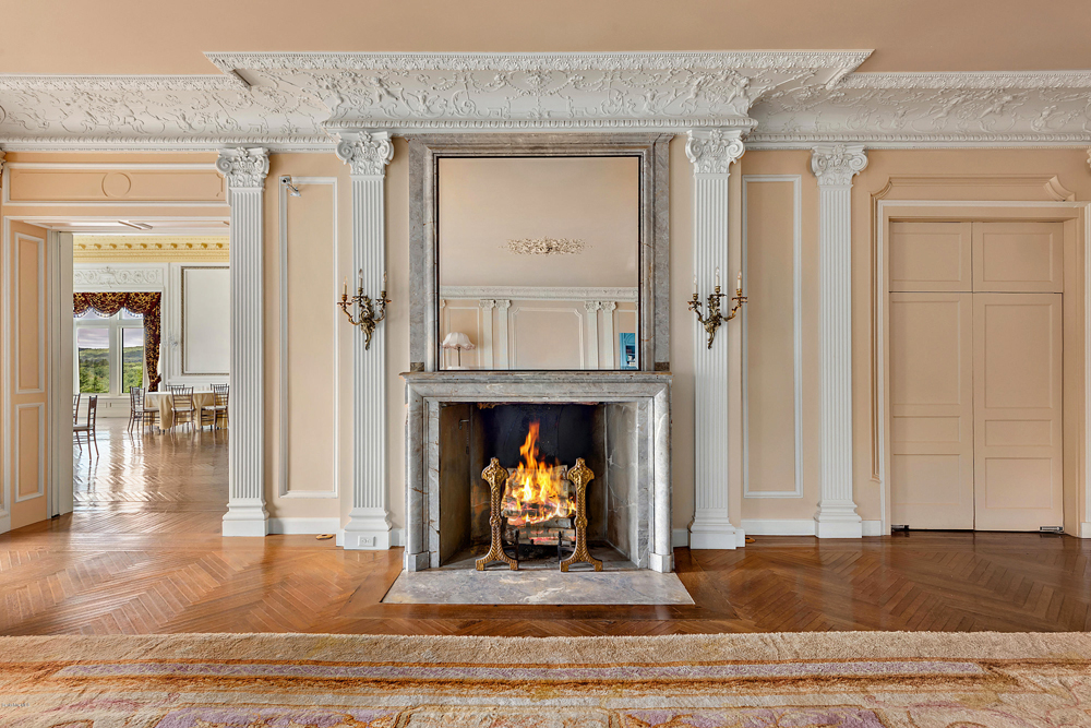 An historic stone fireplace in the spacious lobby off to the side of the dining/ballroom area