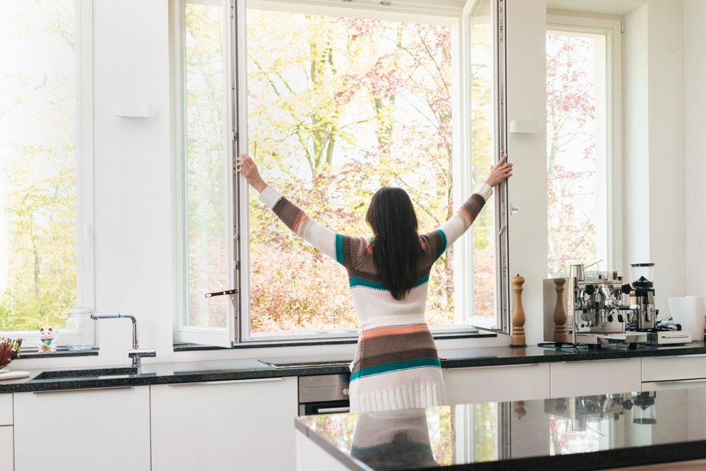 Person opening windows in a kitchen