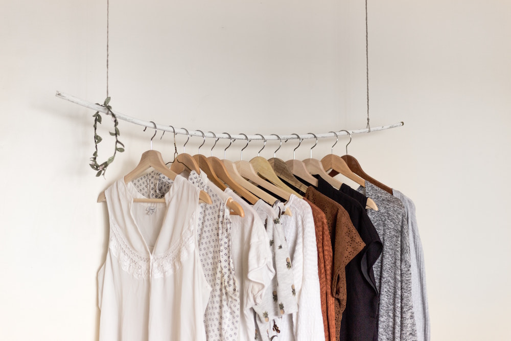 clothes on hangers in front of white wall