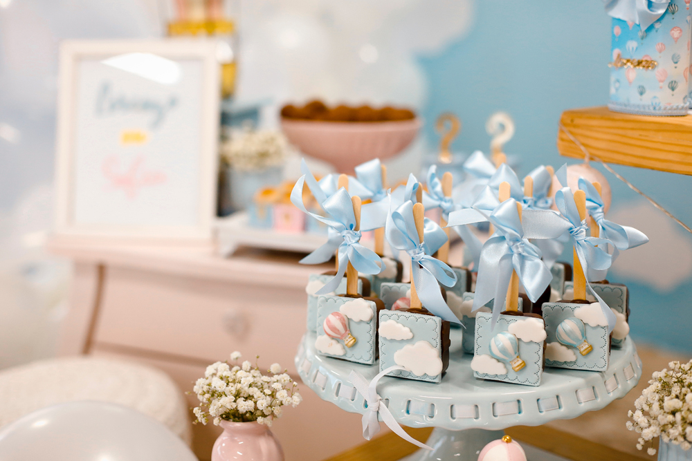 Balloons, gifts and desserts on a table for a baby shower celebration