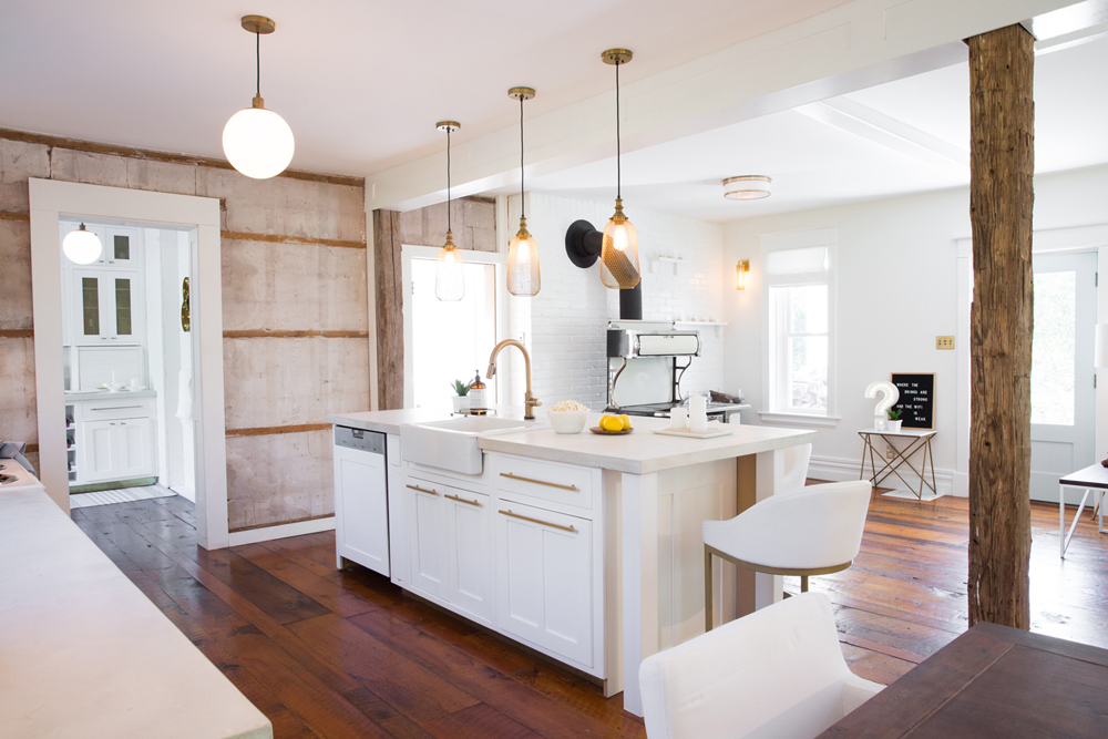 A white rustic farmhouse kitchen with a separate pantry entrance off to the side