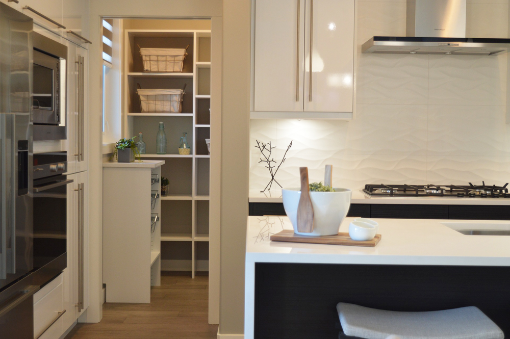 A walk-in pantry off to the side of the kitchen island with plenty of storage space