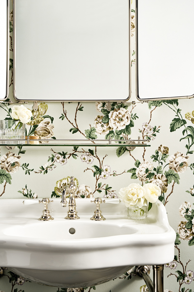 A tangle of tulips, roses and ranunculi climbs a trellis of branches in this stunning wallcovering