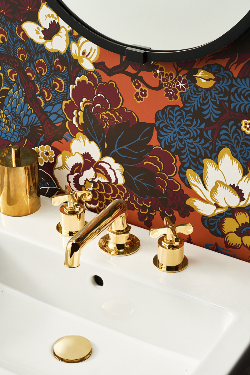 Vibrant, stylized chinoiserie patterned wallpaper in a powder room