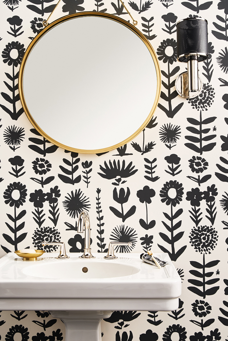 A whimsical black-and-white patterned wallpaper featuring mod botanical blooms