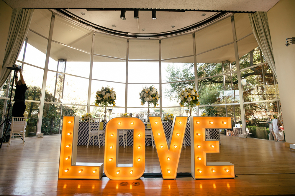 Large, brightly lit letters that spell out LOVE in gold
