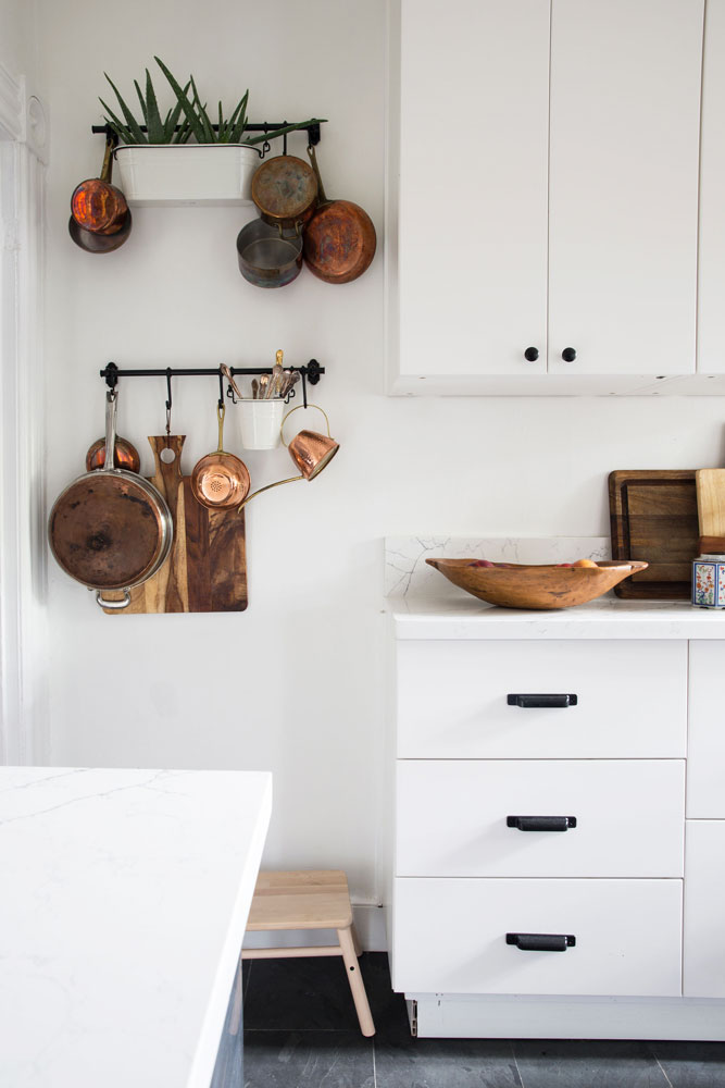 basic white kitchen with antique copper pots and vintage wood