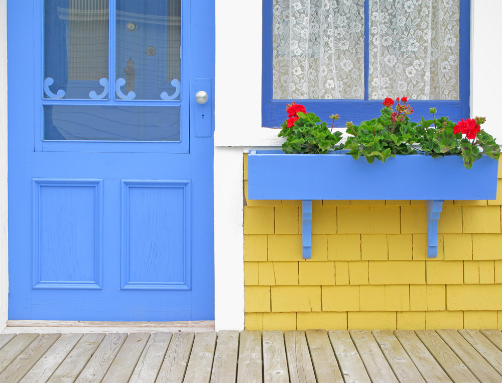 Blue door and window box with Geraniums