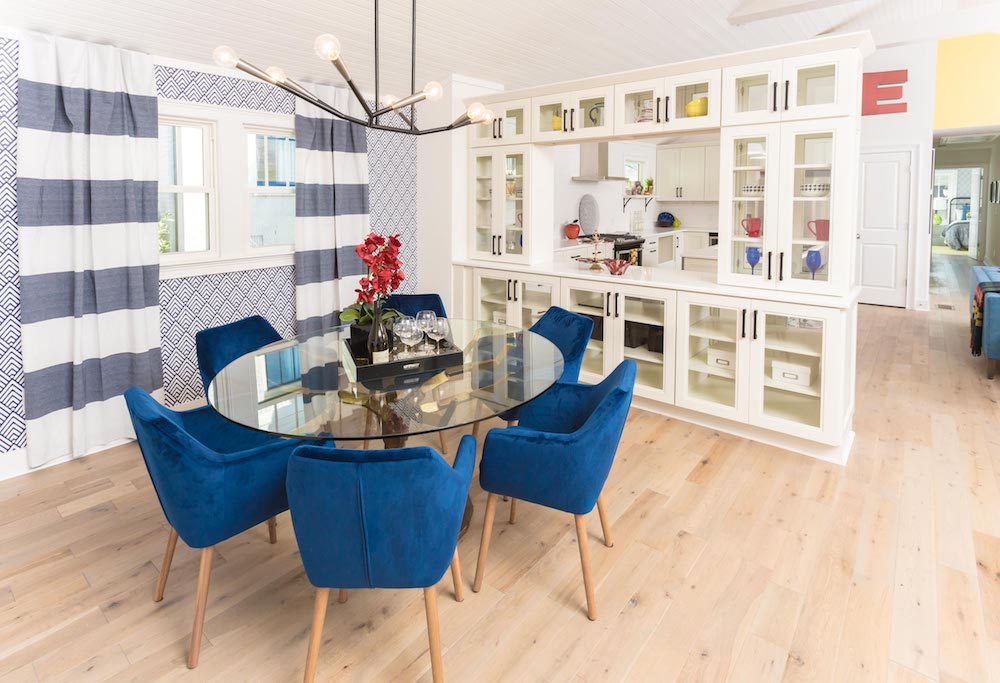 modern dining room with patterned wallpaper and blue striped curtains