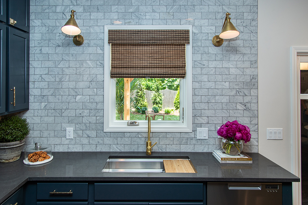 modern kitchen with grey backsplash and blue cabinets