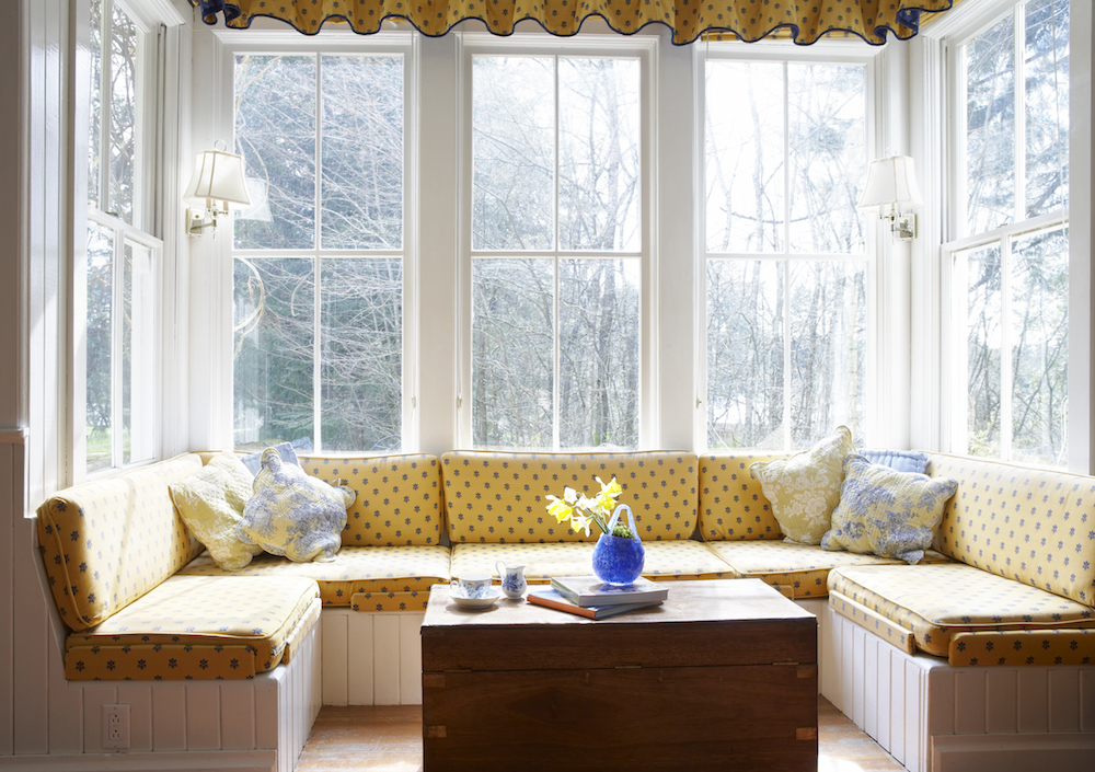 Ppinted window seat with table and printed valance at bay window