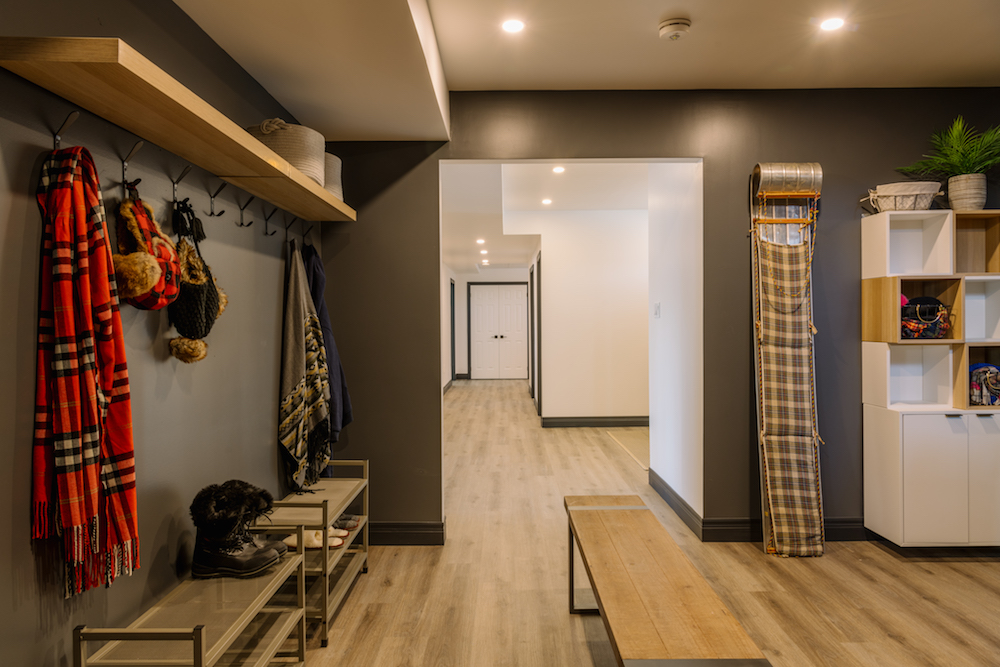 Mudroom with dark walls and a large wooden bench