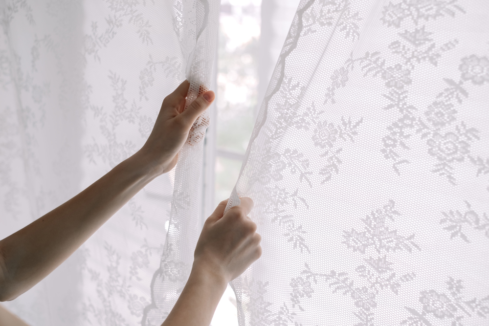 Woman closing her curtains