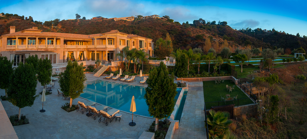 The exterior of a Beverly Hills mansion with a swimming pool