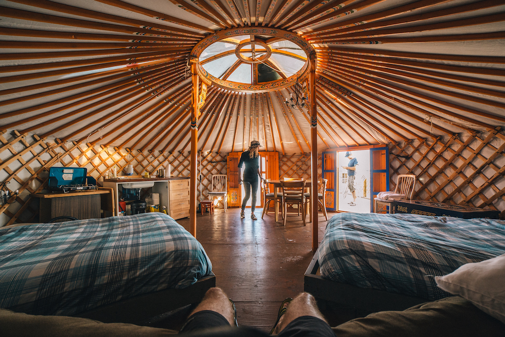 plaid beds inside wood-detail yurt