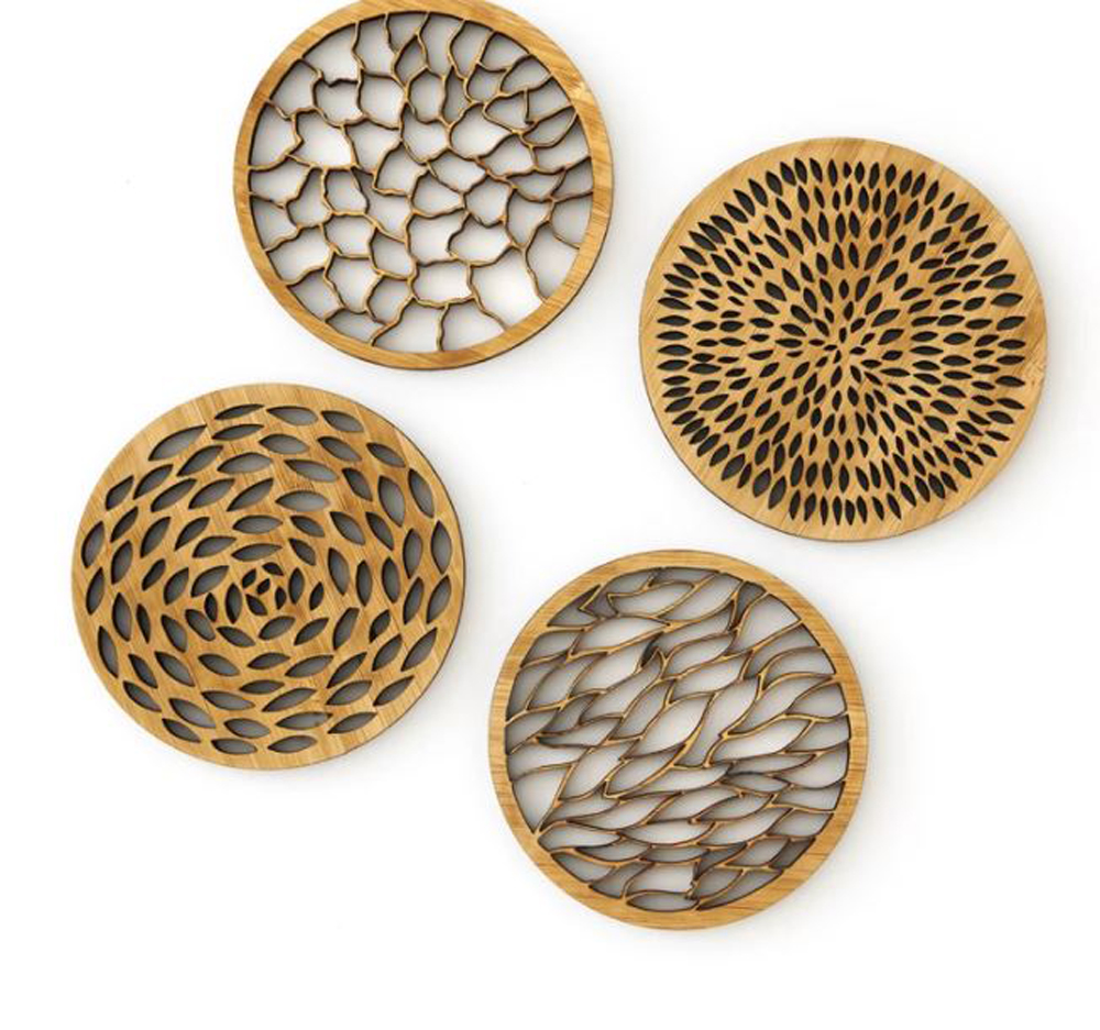 Four abstract bamboo coasters against a white background