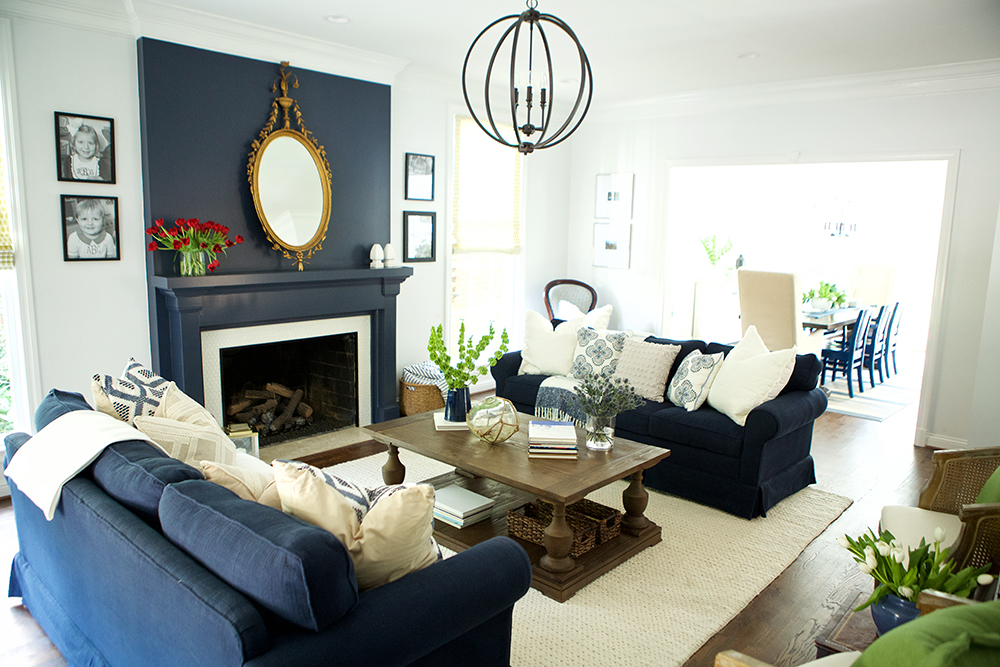 [Alt text] classic white living room with navy accent wall and couches