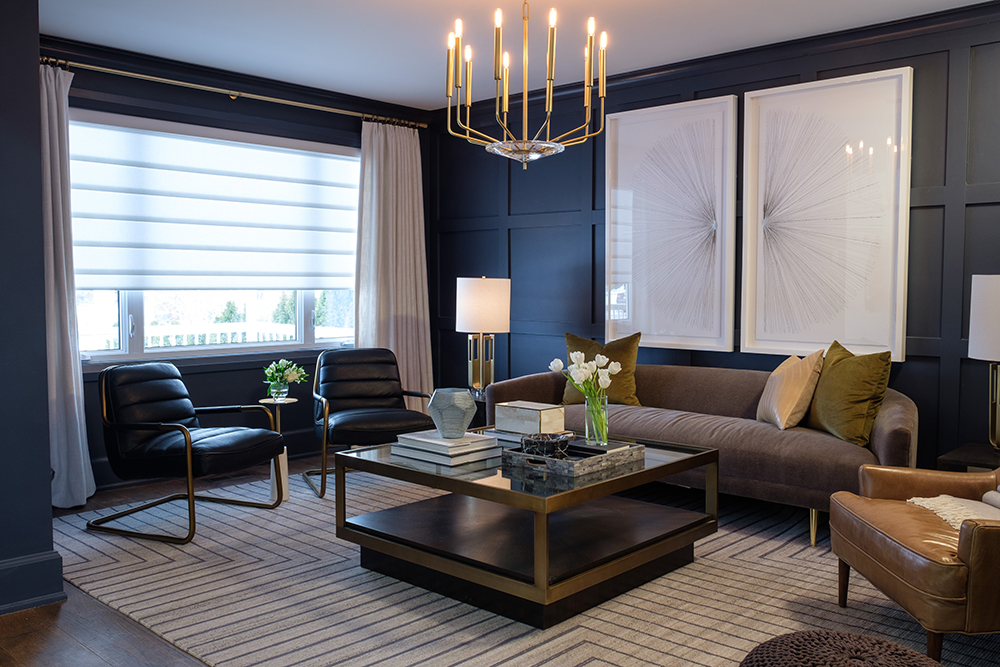 modern dark grey living room with matching framed wall art, brown couch and metallic light fixture