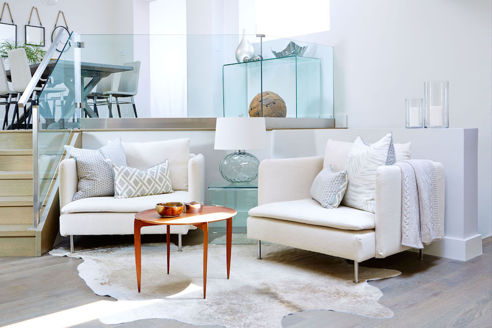 white living room with glass table, lamp and dividers