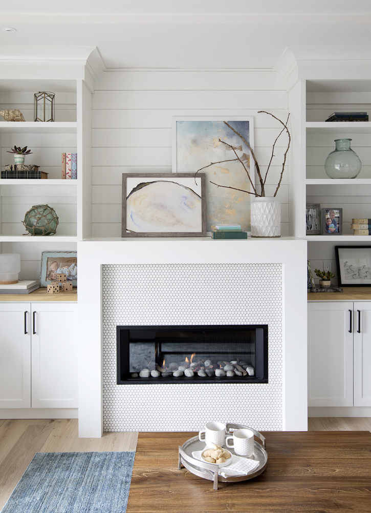 white living room wall with white shelving and fireplace