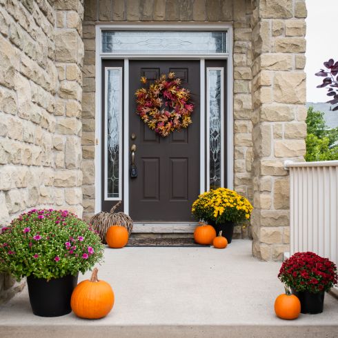 Grey brick home with gorgeous fall curb appeal