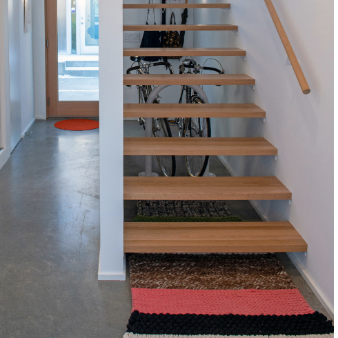 A shot of a modern open wooden staircase and entryway
