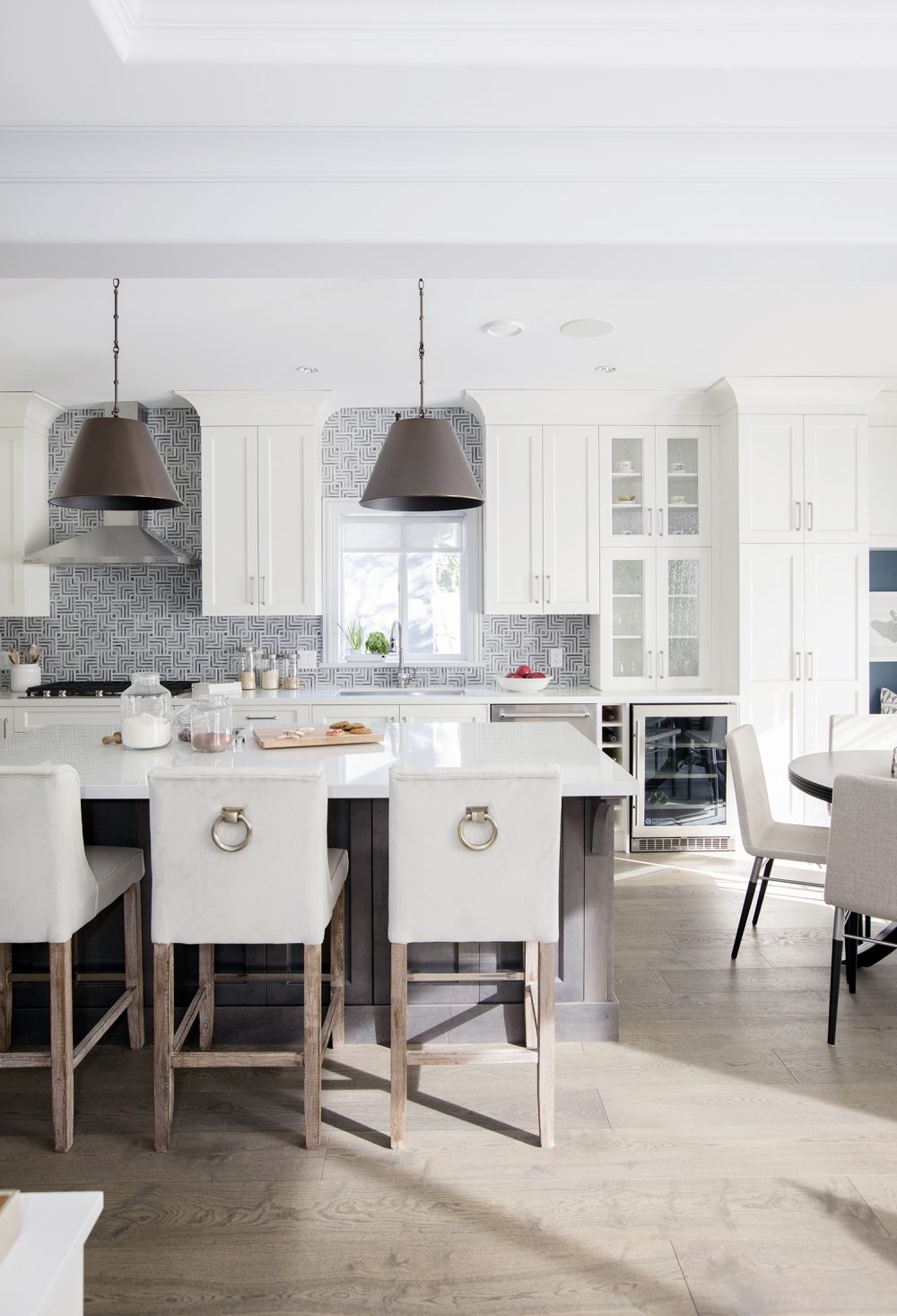 Modern white kitchen with exotic backsplash tiles.